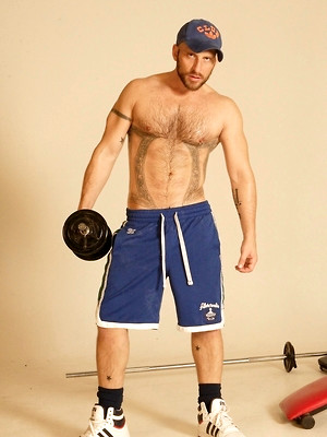 Gay pics of Strong hairy gay athlete Aitor Crash strips naked while lifting weights